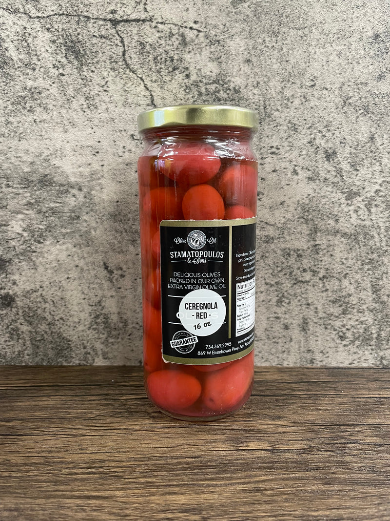 red cerignola olives in a jar with background, contains pits and marinated in brine
